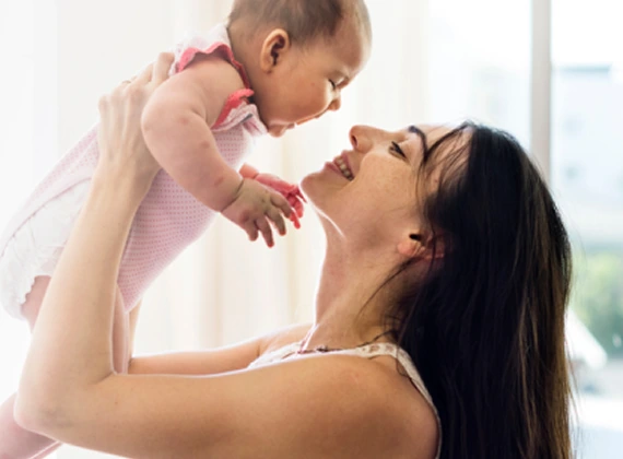 Mother lifting her baby